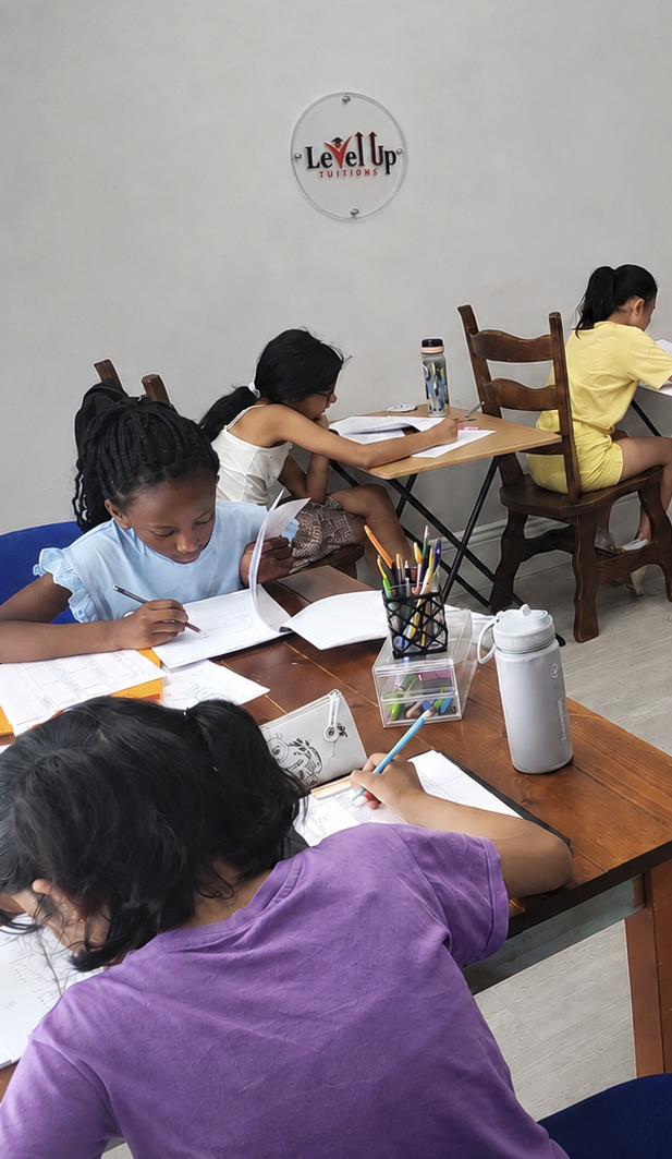 Children completing a mock test at Level Up Tuitions